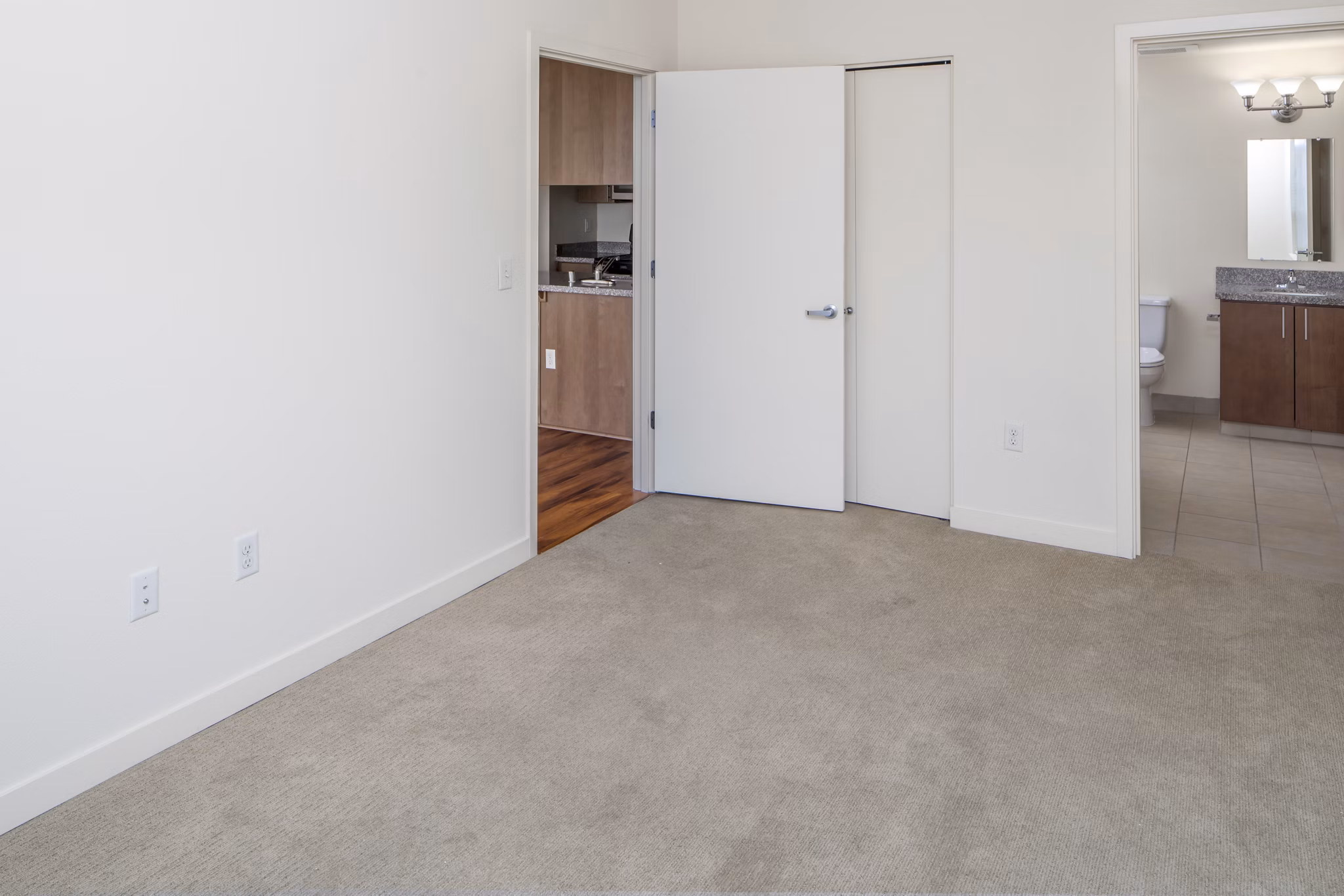 Bedroom with elegant decor and large windows in The Felix Apartments, a luxury Greystar property