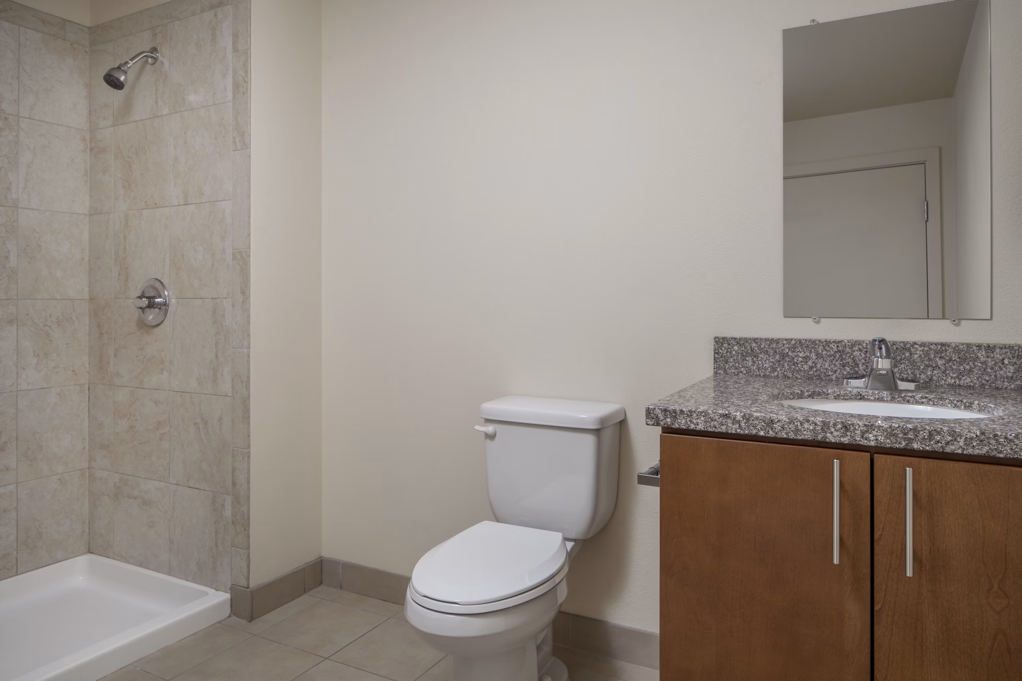 Modern bathroom featuring sleek fixtures and marble countertops at The Felix Apartments