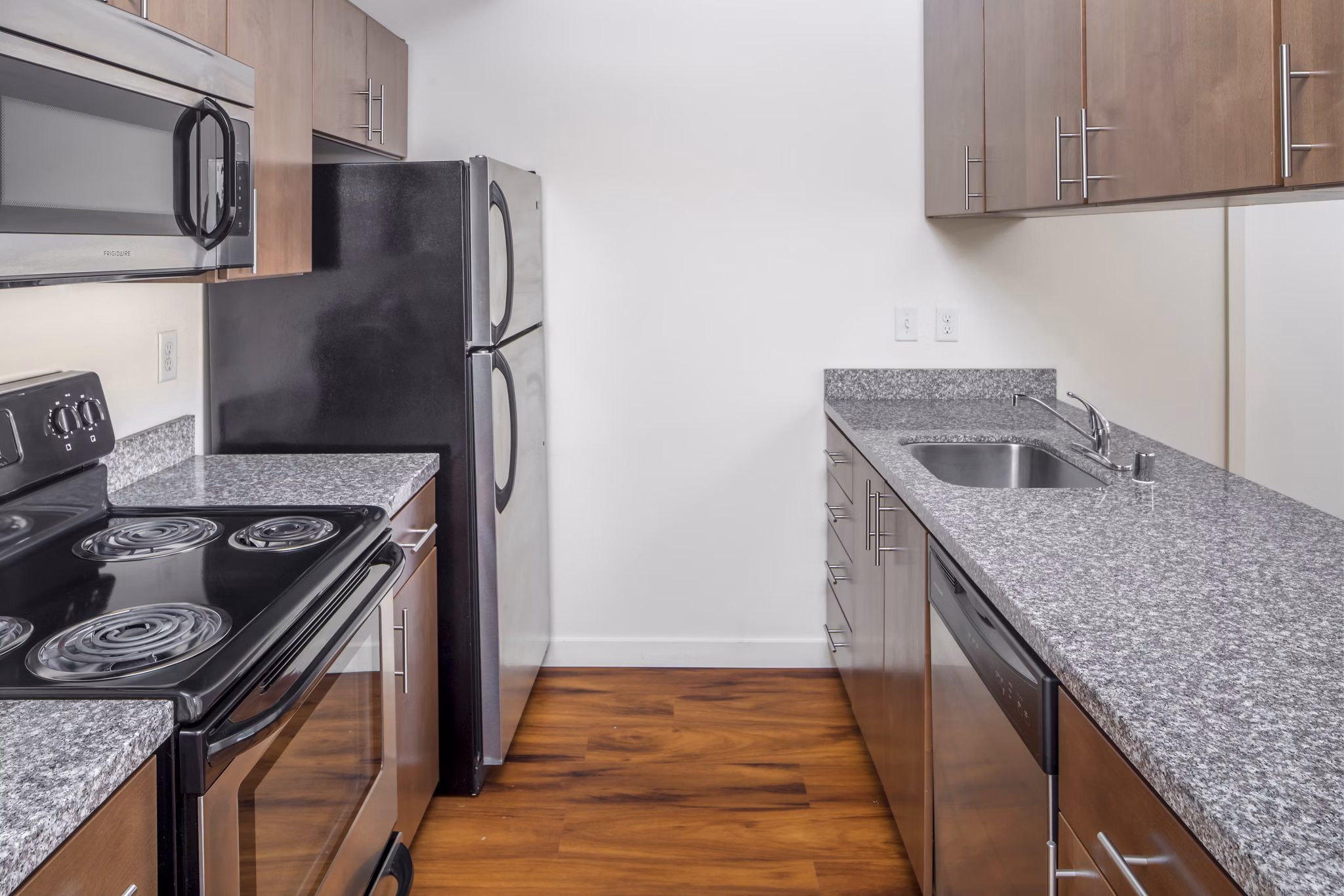 Modern kitchen with stainless steel appliances at The Felix Apartments