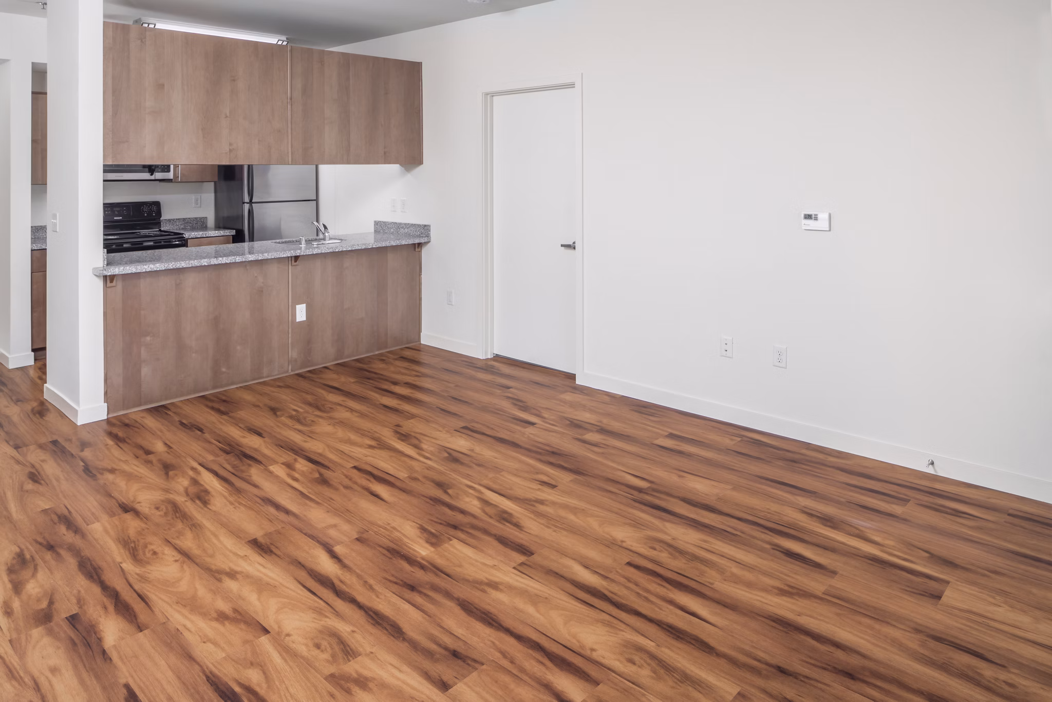 Spacious living room with modern decor at The Felix Apartments