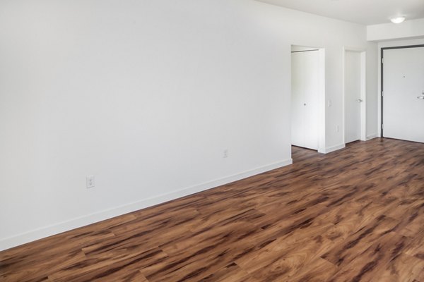 Spacious living room featuring stylish decor and natural light at The Felix Apartments