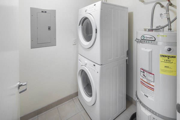 Laundry room with modern washers and dryers at The Felix Apartments, offering convenience and style in urban living