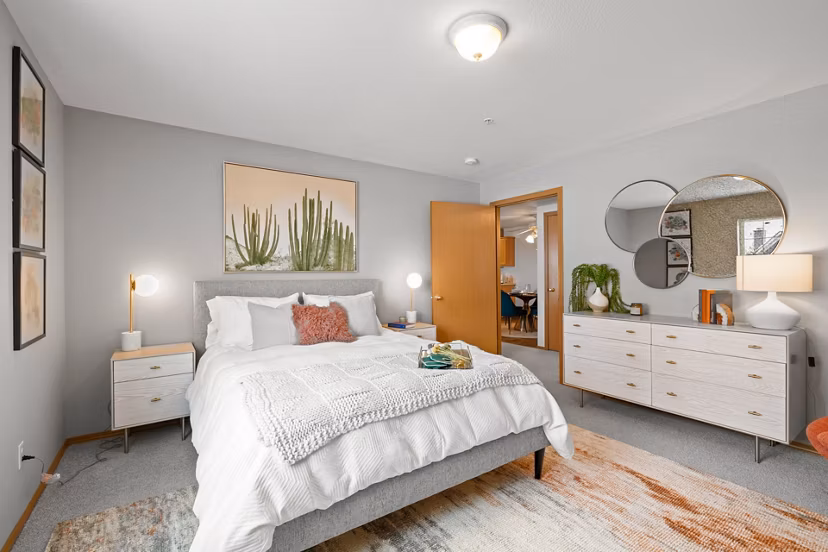 Bedroom with cozy decor and elegant furniture in Highland Hills Apartments