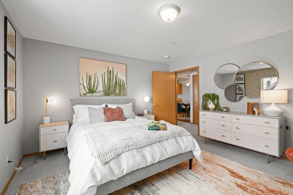 Bedroom with cozy decor and elegant furniture in Highland Hills Apartments