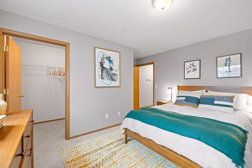 Cozy bedroom with designer furnishings at Highland Hills Apartments