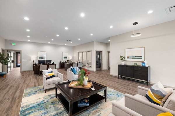 Clubhouse with modern decor and spacious seating at Highland Hills Apartments, perfect for social gatherings and community events