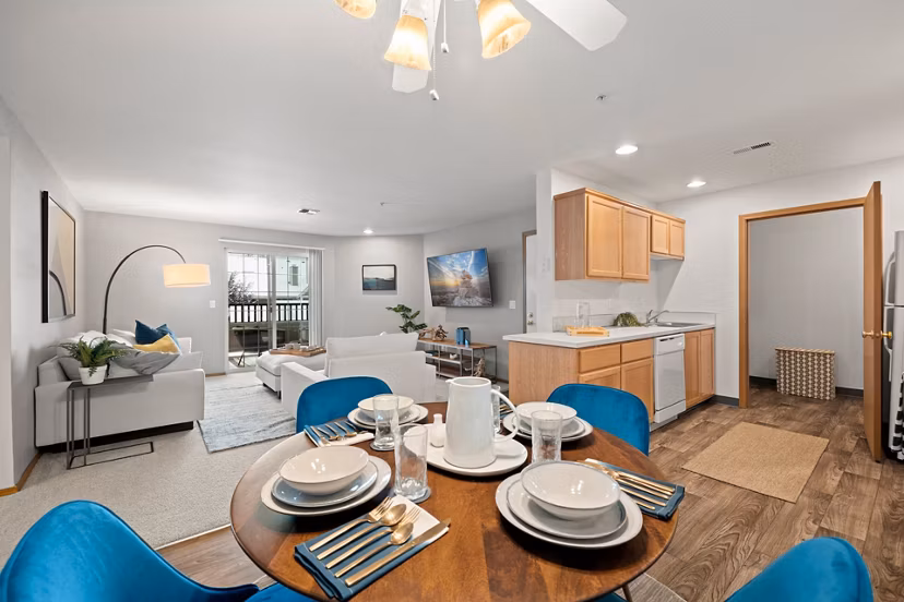 Dining area with sleek furnishings and ample lighting at Highland Hills Apartments