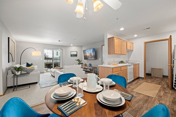 Dining area with sleek furnishings and ample lighting at Highland Hills Apartments