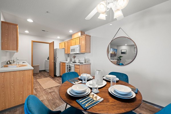 Dining area featuring modern decor and elegant lighting at Highland Hills Apartments