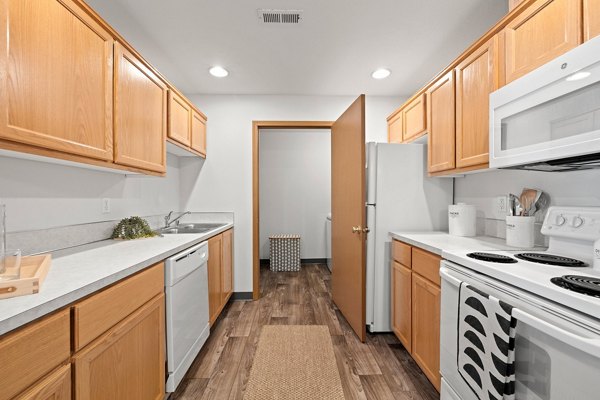 Modern kitchen with stainless steel appliances at Highland Hills Apartments