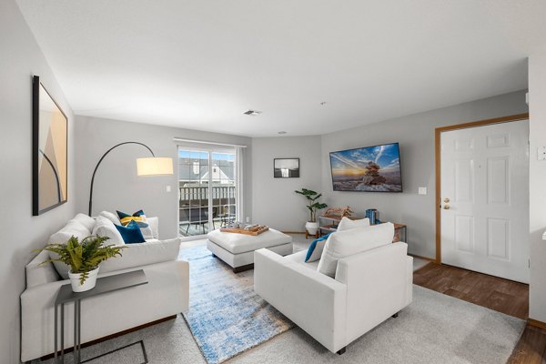 Cozy living room featuring plush seating and modern dÃ©cor at Highland Hills Apartments