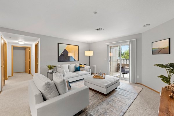 Spacious living room with modern furnishings in Highland Hills Apartments
