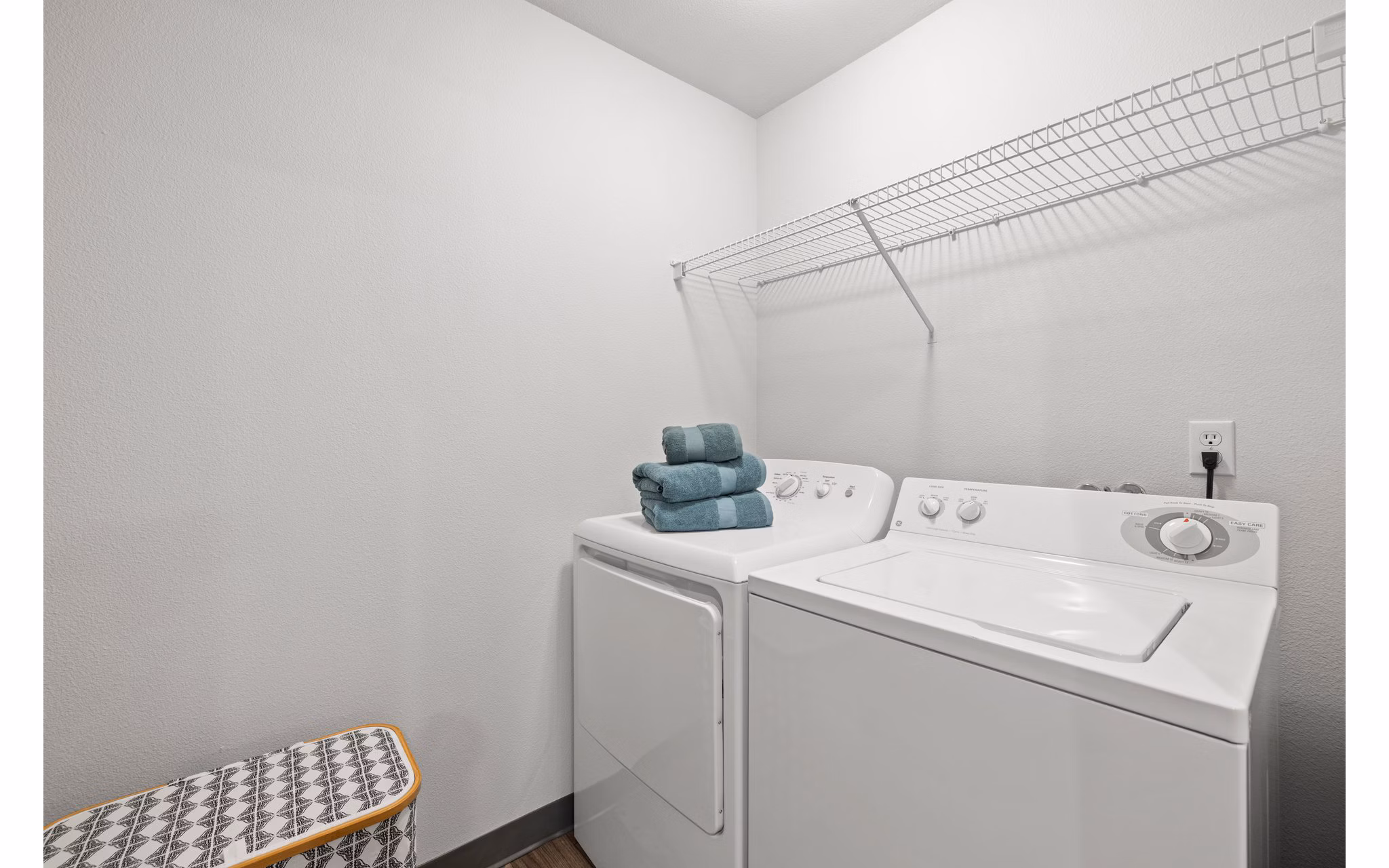 Laundry room with modern machines and ample folding space at Highland Hills Apartments