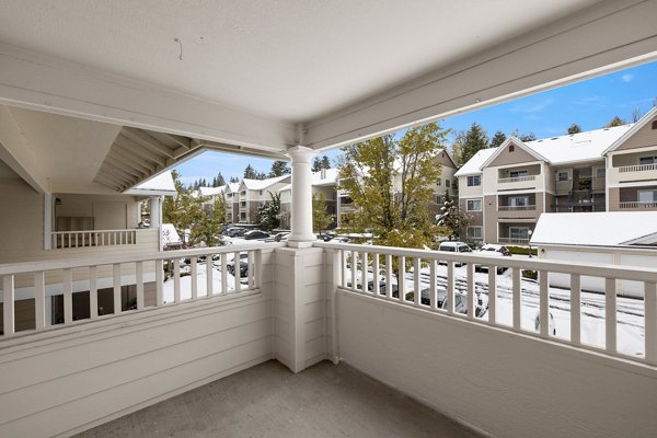 Cozy patio with greenery at Highland Hills Apartments, an upscale feature for relaxation and outdoor enjoyment in elegant surroundings