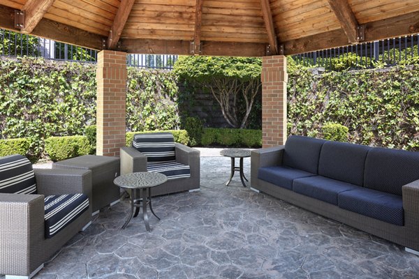 Patio area at Highland Hills Apartments featuring outdoor seating and lush landscaping