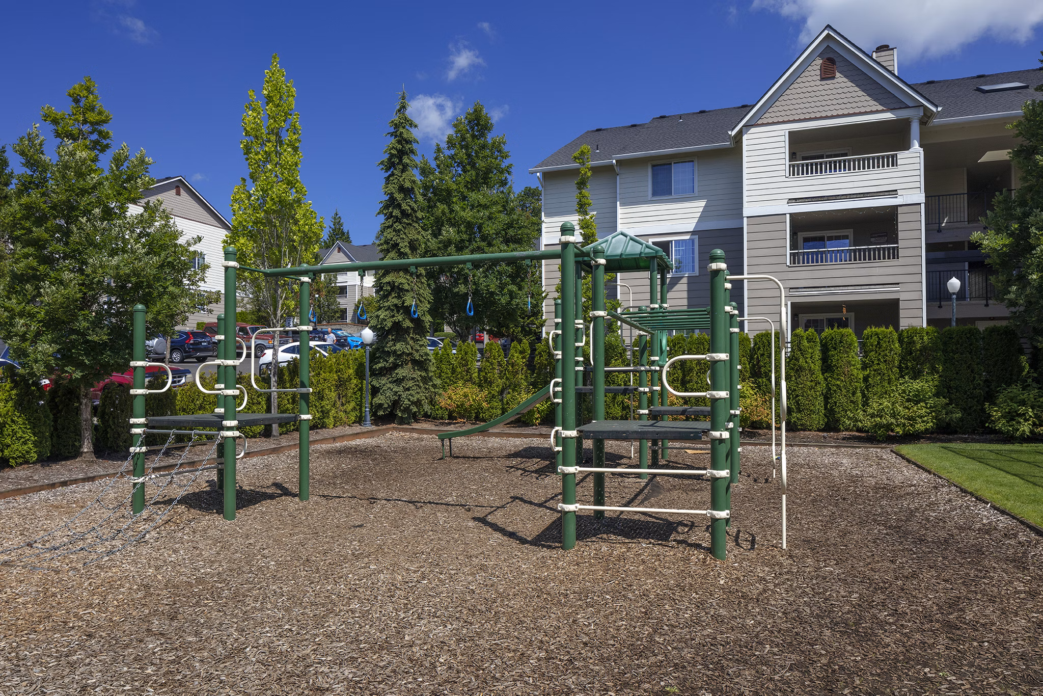 Playground with modern equipment at Highland Hills Apartments, ideal for active families seeking a vibrant community space