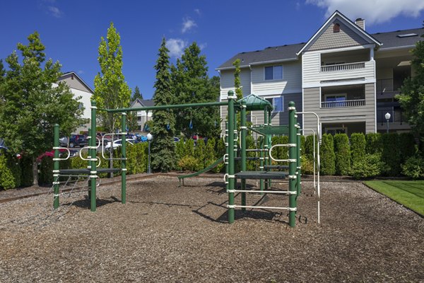 Playground with modern equipment at Highland Hills Apartments, ideal for active families seeking a vibrant community space