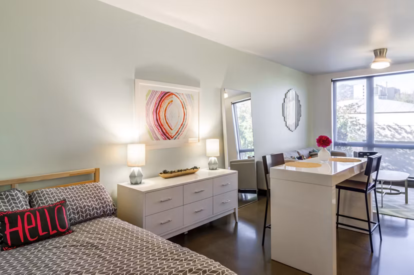 Addy Apartments: Cozy bedroom with modern furnishings in luxury apartment community