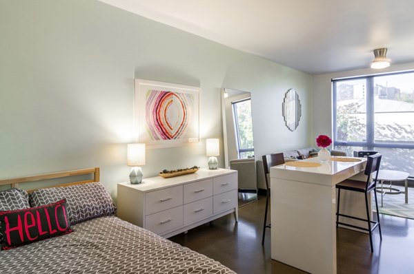 Addy Apartments: Cozy bedroom with modern furnishings in luxury apartment community