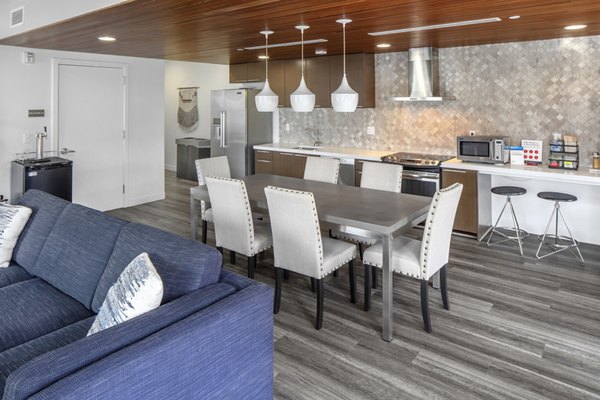 Modern clubhouse with stylish seating and billiards table at The Addy Apartments