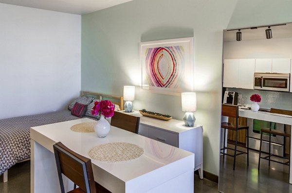 Dining room featuring elegant furnishings and designer lighting at The Addy Apartments