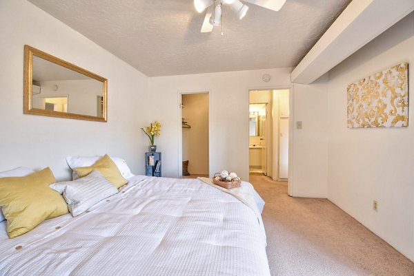Contemporary bedroom with elegant furnishings in Desert Creek Apartments