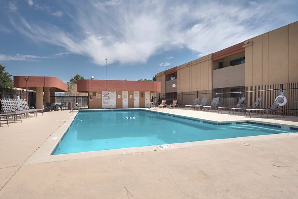 Resort-style pool area with sun loungers at Desert Creek Apartments, a luxury Greystar community, perfect for relaxation and leisure