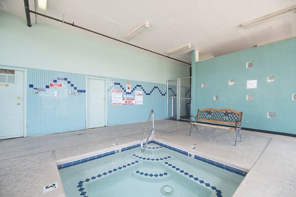 Relaxing hot tub surrounded by lush greenery at Desert Creek Apartments, a luxury residential community