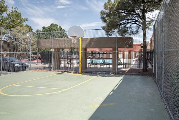 Indoor basketball court at Desert Creek Apartments with hardwood floors and bright lighting, ideal for recreation and sports activities