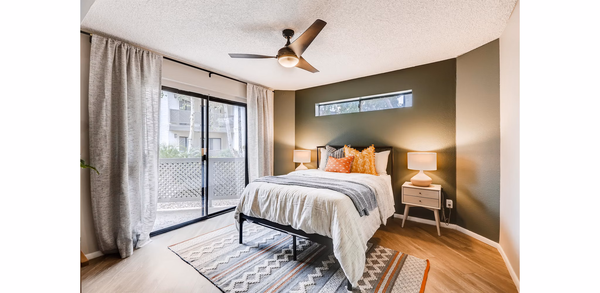 Inviting bedroom with modern decor at Genoa Lakes Apartments featuring plush bedding and natural light
