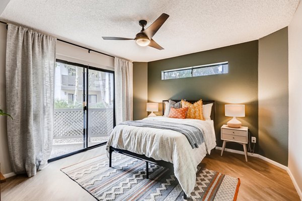 Inviting bedroom with modern decor at Genoa Lakes Apartments featuring plush bedding and natural light