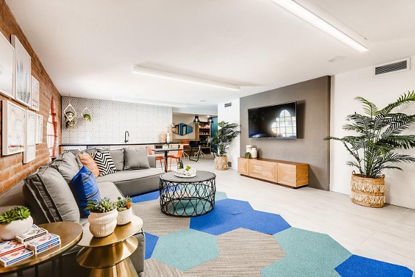 Genoa Lakes Apartments: Modern clubhouse with luxury seating and gaming areas, ideal for socializing and relaxation