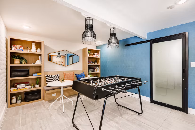 Entertaining game room with billiards and seating area at Genoa Lakes Apartments