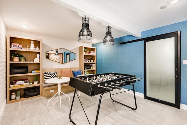 Entertaining game room with billiards and seating area at Genoa Lakes Apartments