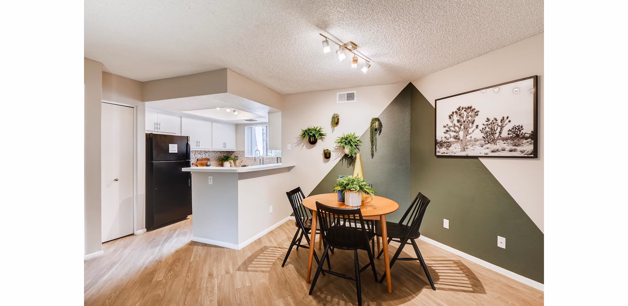 Dining area with modern furnishings at Genoa Lakes Apartments, featuring stylish decor and ample natural light Ideal luxury living space for residents