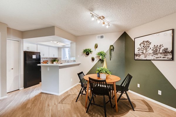 Dining area with modern furnishings at Genoa Lakes Apartments, featuring stylish decor and ample natural light Ideal luxury living space for residents