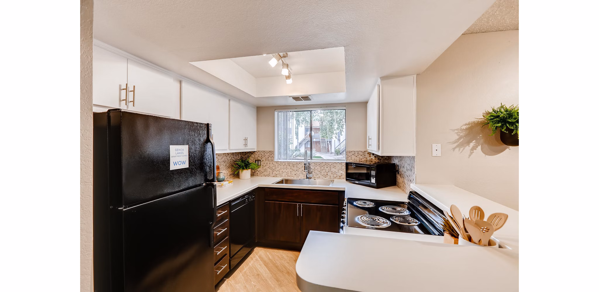Modern kitchen with stainless steel appliances at Genoa Lakes Apartments