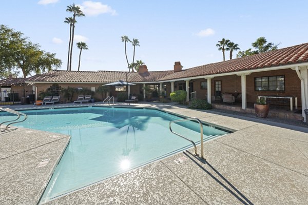 1000 Genoa Lakes Apartments: Luxurious pool area with lounge chairs and umbrellas for relaxation