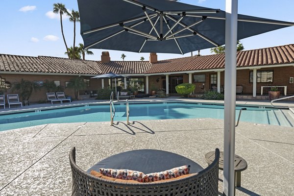 Inviting pool surrounded by lush landscaping at 1000 Genoa Lakes Apartments, perfect for luxury relaxation