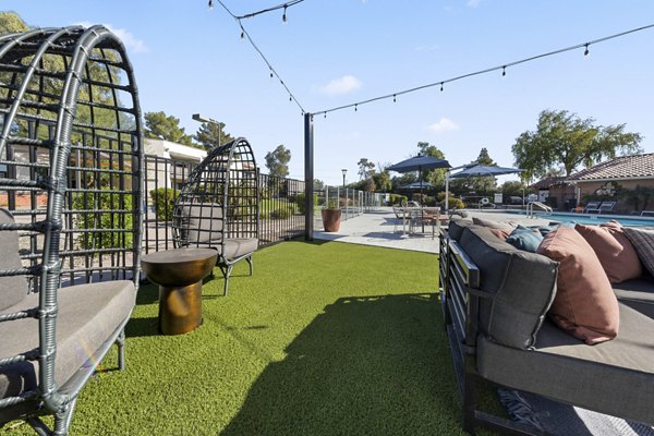 Courtyard featuring serene garden and seating area at 1000 Genoa Lakes Apartments, a Greystar luxury property