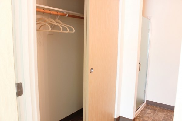 Spacious bedroom with modern decor at Timberhill Meadows Apartments, offering luxury living with ample natural light and premium finishes