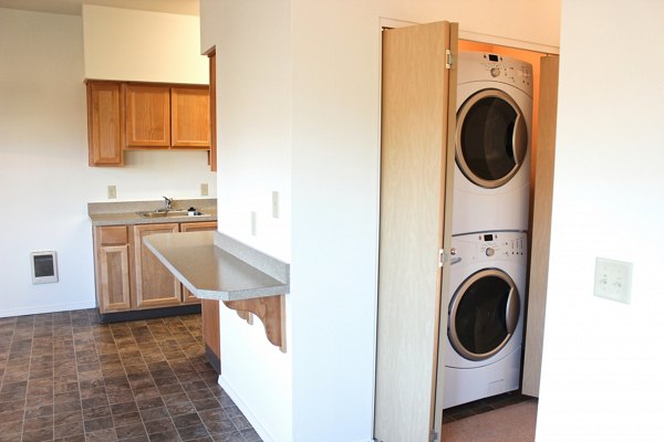 Laundry room with energy-efficient washers and dryers at Timberhill Meadows Apartments