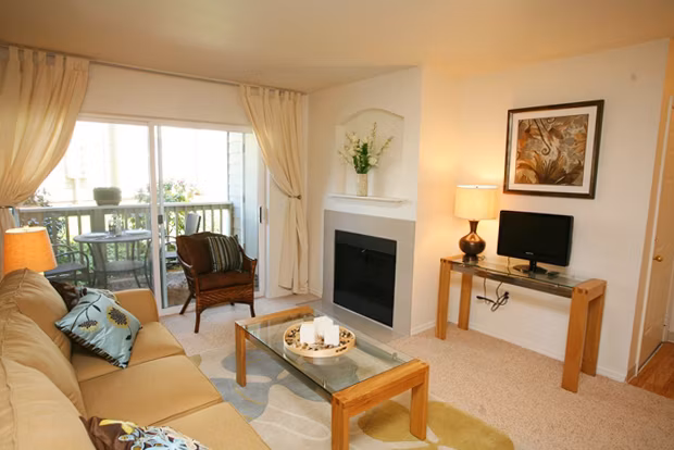 Open-concept living room with modern decor at Jackson School Village Apartments, featuring luxury finishes and abundant natural light