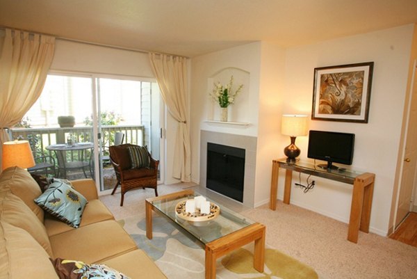 Open-concept living room with modern decor at Jackson School Village Apartments, featuring luxury finishes and abundant natural light
