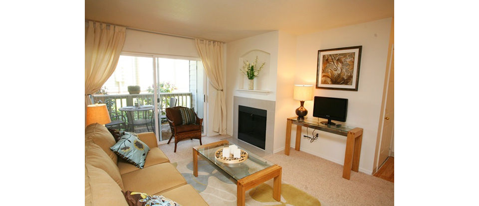 Open-concept living room with modern decor at Jackson School Village Apartments, featuring luxury finishes and abundant natural light