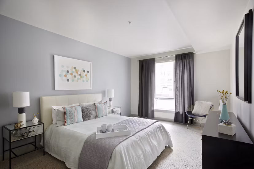 Cozy bedroom with modern furnishings at Enso Apartments in a Greystar luxury community