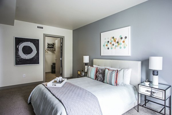 Cozy bedroom with modern furnishings at Enso Apartments in a Greystar luxury community