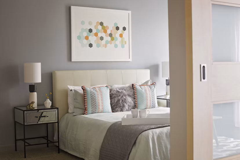 Enso Apartments: Cozy bedroom with modern decor and natural light