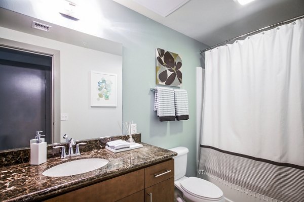 Modern bathroom with elegant fixtures at Enso Apartments, a Greystar luxury apartment community