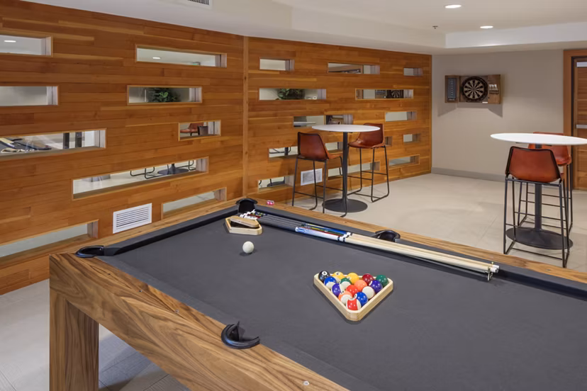 Modern clubhouse with communal seating and entertainment options at Enso Apartments, part of Greystar's luxury living portfolio